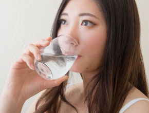 薬を飲む女性